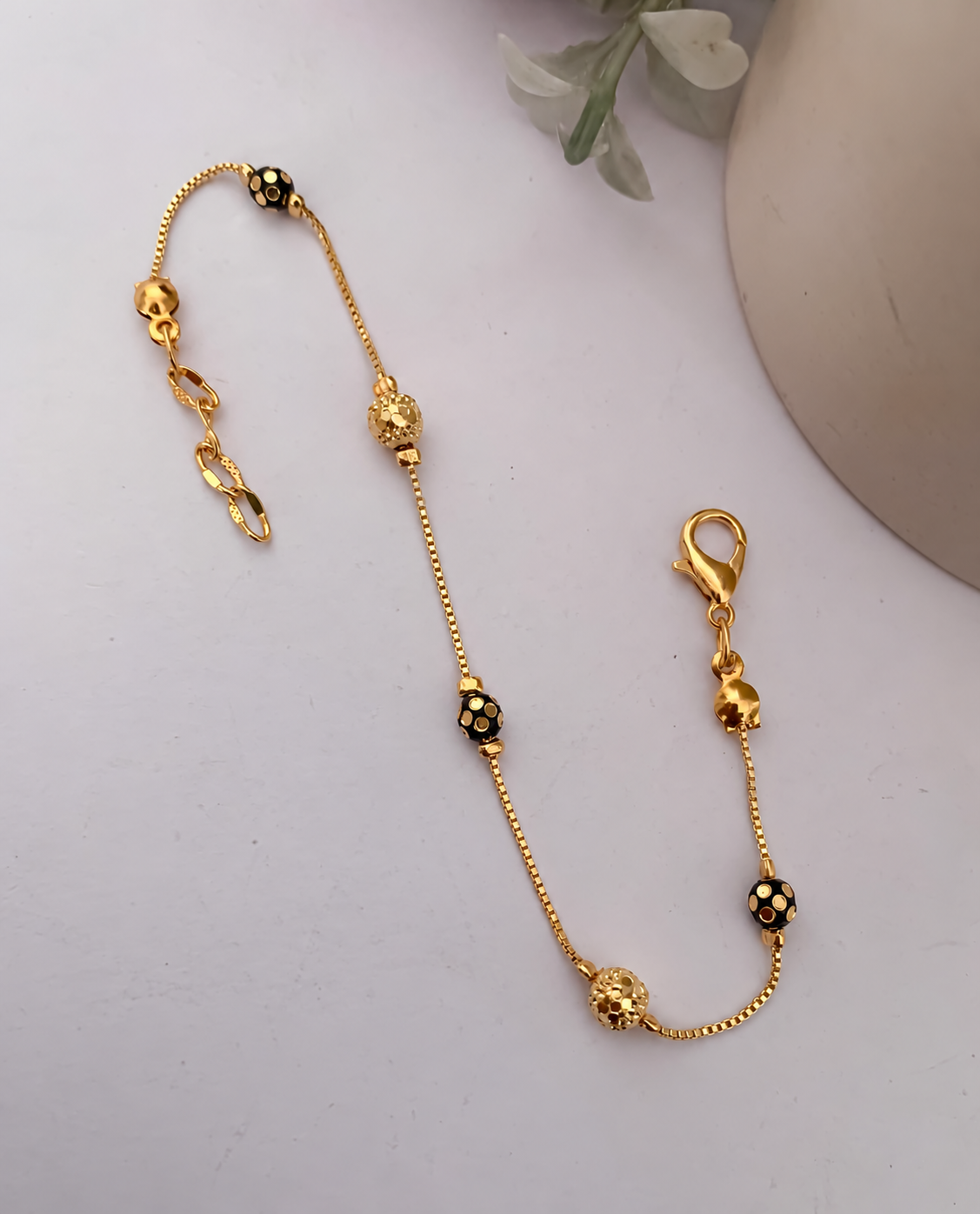 Black bead gold chain bracelet